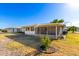 Back exterior view showing the house and screened patio at 10012 W Sandstone Dr, Sun City, AZ 85351