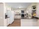 Kitchen with white cabinets, island and hardwood floors at 10012 W Sandstone Dr, Sun City, AZ 85351