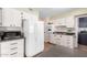 Bright eat-in kitchen, featuring white cabinets, granite countertops, and stainless steel appliances at 10012 W Sandstone Dr, Sun City, AZ 85351