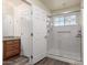 Bathroom with shower, granite countertop, and wood cabinets at 10035 E Diamond Dr, Sun Lakes, AZ 85248