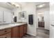 Bathroom with granite countertop, wood cabinets, and a large mirror at 10035 E Diamond Dr, Sun Lakes, AZ 85248