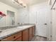 Bathroom with granite countertop, wood cabinets, and a large mirror at 10035 E Diamond Dr, Sun Lakes, AZ 85248