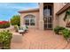 Brick paved patio with seating area and lush landscaping at 10035 E Diamond Dr, Sun Lakes, AZ 85248