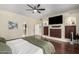 Main bedroom with walk-in closet, built-in entertainment center, and hardwood floors at 10035 E Diamond Dr, Sun Lakes, AZ 85248