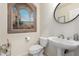 Powder room with artistic alcove, pedestal sink, and toilet at 10035 E Diamond Dr, Sun Lakes, AZ 85248