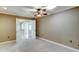 Spacious bedroom with ceiling fan and mirrored closet doors at 10252 N 105Th Dr, Sun City, AZ 85351