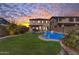 Stunning backyard with pool, spa, and lush landscaping at sunset at 10307 E Nopal Ave, Mesa, AZ 85209