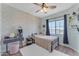 Bedroom with a bed, vanity, and patterned wallpaper at 10307 E Nopal Ave, Mesa, AZ 85209