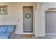 Inviting front entrance with gray door, wreath, and comfy seating at 10307 E Nopal Ave, Mesa, AZ 85209