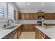 Modern kitchen with wooden cabinets, white countertops, and herringbone backsplash at 10307 E Nopal Ave, Mesa, AZ 85209