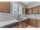 Modern kitchen with wooden cabinets, white countertops, and herringbone backsplash at 10307 E Nopal Ave, Mesa, AZ 85209