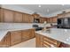 Modern kitchen with white quartz countertops and wood cabinets at 10307 E Nopal Ave, Mesa, AZ 85209