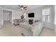 Spacious living room with gray sofas, ceiling fan, and fireplace at 10307 E Nopal Ave, Mesa, AZ 85209