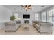 Spacious living room with gray sofas, ceiling fan, and fireplace at 10307 E Nopal Ave, Mesa, AZ 85209