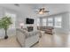 Spacious living room with gray sofas, ceiling fan, and fireplace at 10307 E Nopal Ave, Mesa, AZ 85209