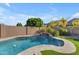 Stunning kidney-shaped pool with a waterfall feature at 10307 E Nopal Ave, Mesa, AZ 85209