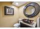 Bathroom boasts a vessel sink and a large circular mirror at 10489 N 99Th St, Scottsdale, AZ 85258