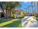 Side view of the house showing landscaping, driveway, and garage at 10489 N 99Th St, Scottsdale, AZ 85258