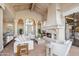 Bright living room with fireplace, white sofas, and view of entryway at 10489 N 99Th St, Scottsdale, AZ 85258