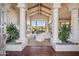 High-ceilinged living room with fireplace, large windows, and hardwood floors at 10489 N 99Th St, Scottsdale, AZ 85258