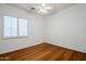 Bright bedroom with wood floors and plantation shutters at 1060 W Silver Creek Rd, Gilbert, AZ 85233