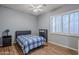 Bedroom with wood floors, ceiling fan, and built-in shelving at 1060 W Silver Creek Rd, Gilbert, AZ 85233