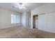 Bedroom with large closet and ceiling fan at 1060 W Silver Creek Rd, Gilbert, AZ 85233