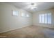 Bright bedroom featuring plantation shutters and ceiling fan at 1060 W Silver Creek Rd, Gilbert, AZ 85233