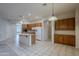 Kitchen boasts an island, ample cabinetry, and a view into the adjacent living room at 1060 W Silver Creek Rd, Gilbert, AZ 85233