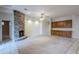 Living room features a stone fireplace and neutral carpeting at 1060 W Silver Creek Rd, Gilbert, AZ 85233