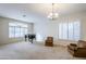 Bright living room with large windows and plantation shutters at 1060 W Silver Creek Rd, Gilbert, AZ 85233