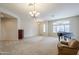 Spacious living room featuring a piano, comfortable seating, and large windows at 1060 W Silver Creek Rd, Gilbert, AZ 85233