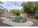 Refreshing kidney-shaped pool and spa with a stone waterfall feature at 1060 W Silver Creek Rd, Gilbert, AZ 85233