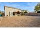 Large backyard with covered patio and view of house at 11025 W Lane Ave, Glendale, AZ 85307