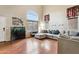 Living room with L-shaped sofa, hardwood floors, and large window at 11025 W Lane Ave, Glendale, AZ 85307