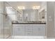 Bathroom with double vanity, marble tile and a large shower at 122 E Orange Blossom Path, Queen Creek, AZ 85140