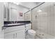 Modern bathroom with single vanity, toilet, and a glass shower at 122 E Orange Blossom Path, Queen Creek, AZ 85140