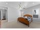 Light and airy bedroom with wood bed frame and ceiling fan at 122 E Orange Blossom Path, Queen Creek, AZ 85140