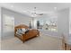 Spacious bedroom with wood bed frame, ceiling fan and plantation shutters at 122 E Orange Blossom Path, Queen Creek, AZ 85140