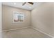 Bright bedroom featuring a ceiling fan and large window with shutters at 122 E Orange Blossom Path, Queen Creek, AZ 85140