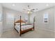 Bedroom with wood post bed, ceiling fan and plantation shutters at 122 E Orange Blossom Path, Queen Creek, AZ 85140