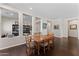 Bright dining room features a wood table with six chairs and dark hardwood floors at 122 E Orange Blossom Path, Queen Creek, AZ 85140