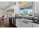 Kitchen with farmhouse sink, stainless steel appliances, and view to backyard at 122 E Orange Blossom Path, Queen Creek, AZ 85140