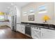 Kitchen with wine cooler, white cabinets, and black countertops at 122 E Orange Blossom Path, Queen Creek, AZ 85140