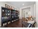 Home office with built-in shelving and hardwood floors at 122 E Orange Blossom Path, Queen Creek, AZ 85140