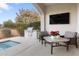 Relaxing patio with outdoor grill, seating area, and large TV at 122 E Orange Blossom Path, Queen Creek, AZ 85140