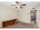 Simple bedroom with ceiling fan and access to another room at 12510 W Brandywine Dr, Sun City West, AZ 85375