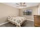 Cozy bedroom with a comfortable bed, ceiling fan, and window coverings at 12510 W Brandywine Dr, Sun City West, AZ 85375