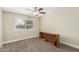 Bright bedroom with window shutters, ceiling fan, and built-in shelving at 12510 W Brandywine Dr, Sun City West, AZ 85375