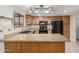 Galley style kitchen with oak cabinets and black appliances at 12510 W Brandywine Dr, Sun City West, AZ 85375